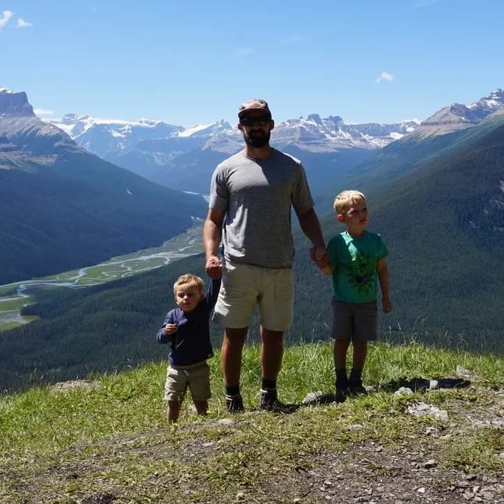 Bob Kephart with two kids on a mountain overlook