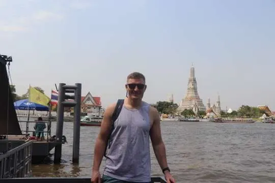 Caleb Kidder standing by a river