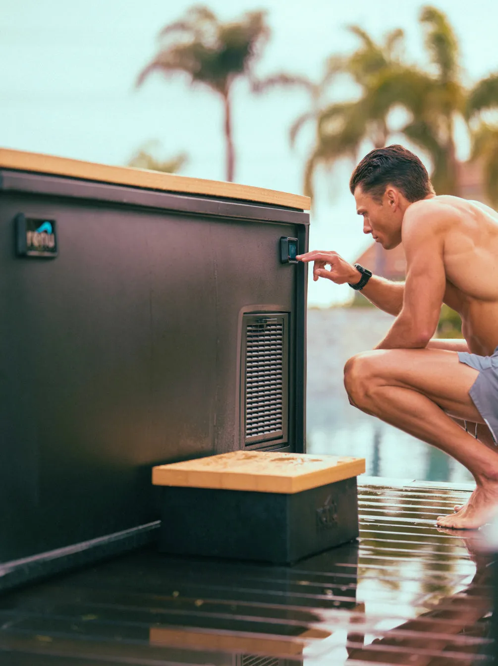 Man crouching to use the touchscreen on the side of the plunge