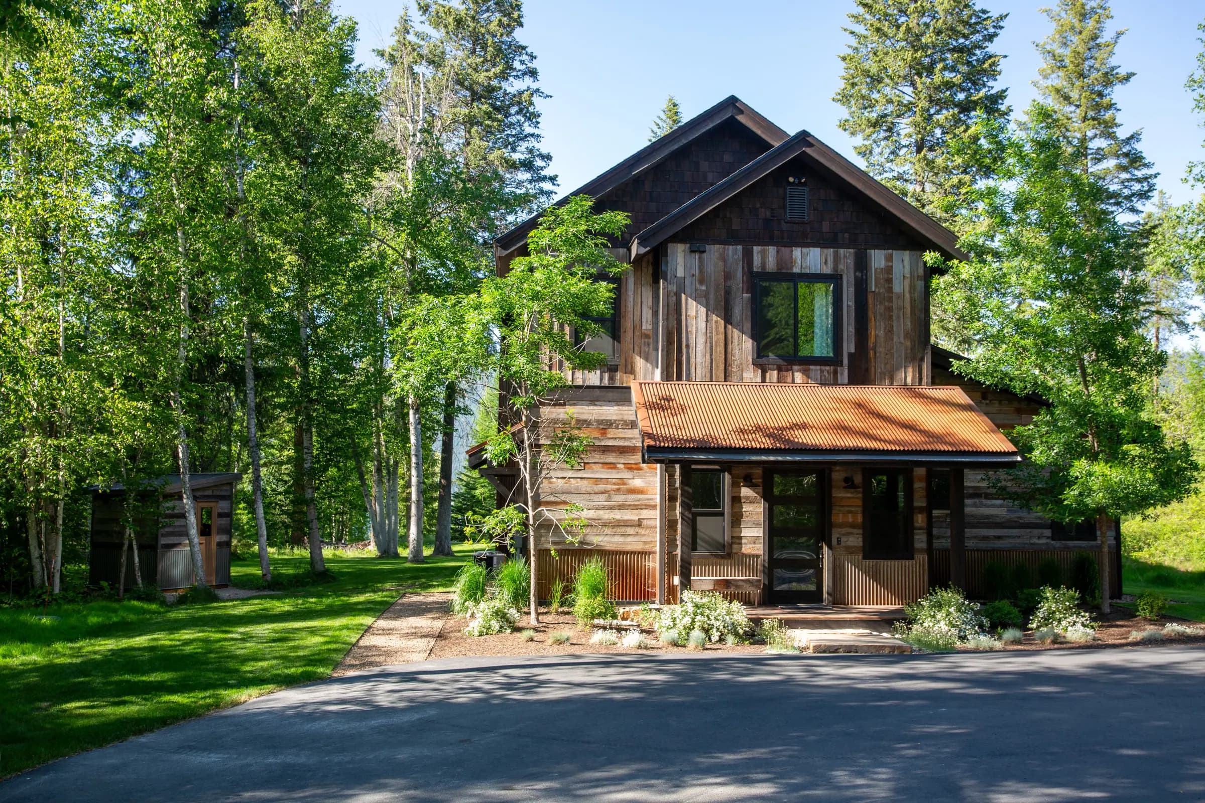 Timber home in Whitefish with a matching reclaimed-wood sauna in the yard