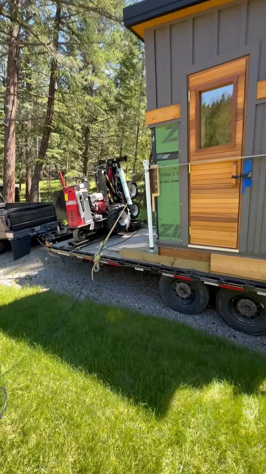 Sauna strapped to a trailer, with the shed mule loaded behind it