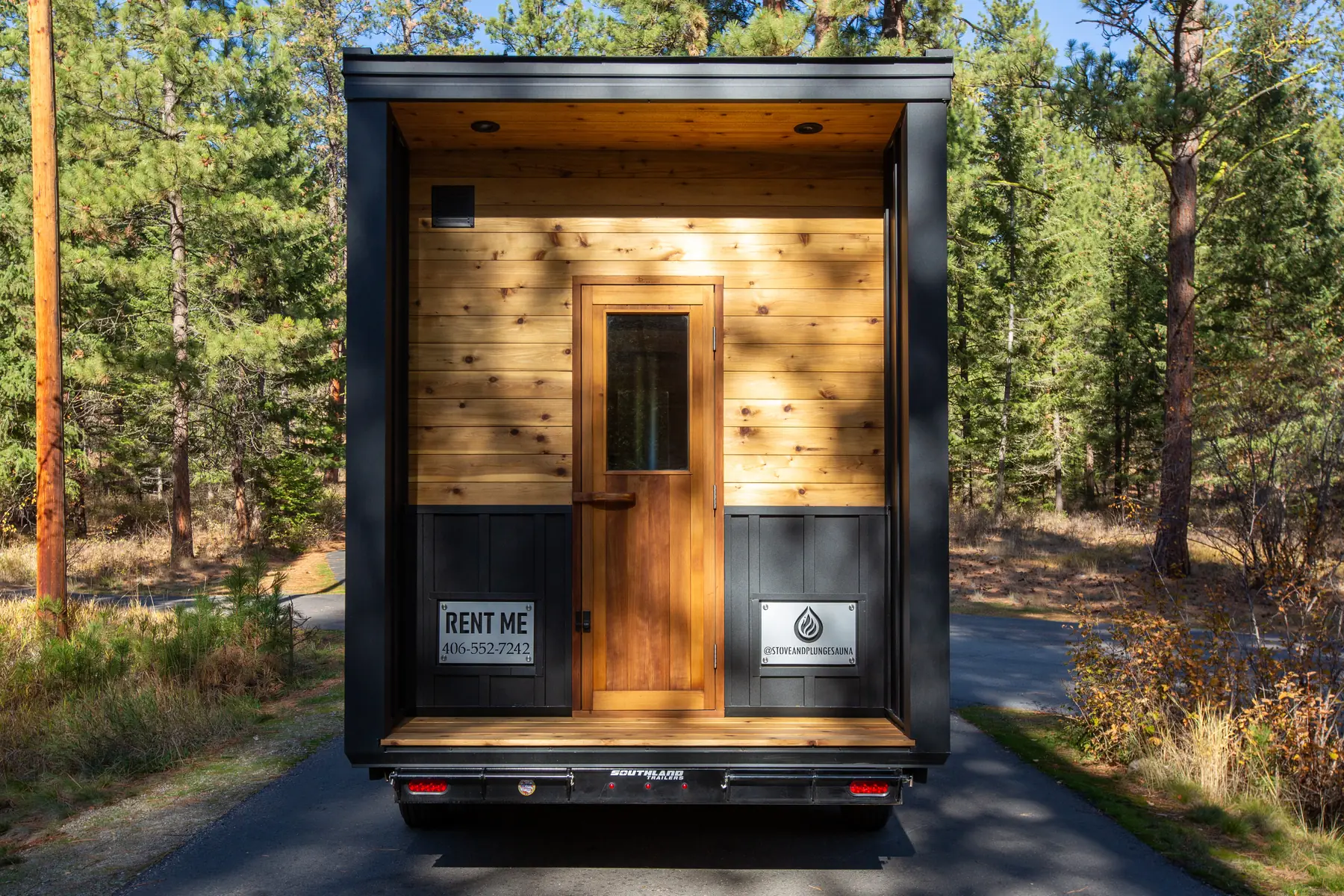 Rear of the Mobile 10C: cedar-lined porch and door with business signs on each side