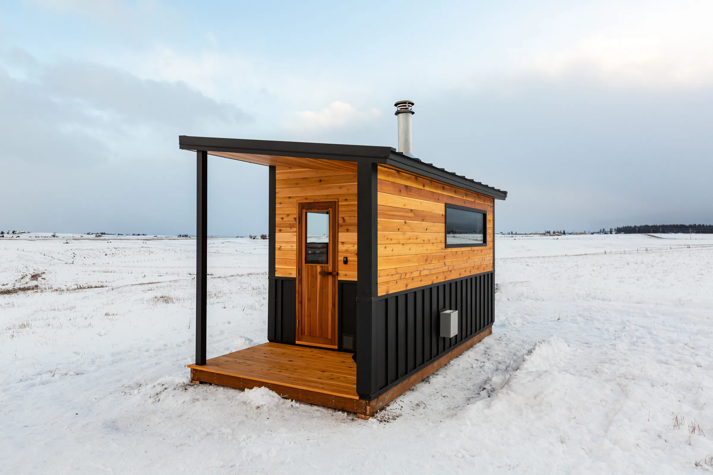 Model N porch and cedar door on a snowy field