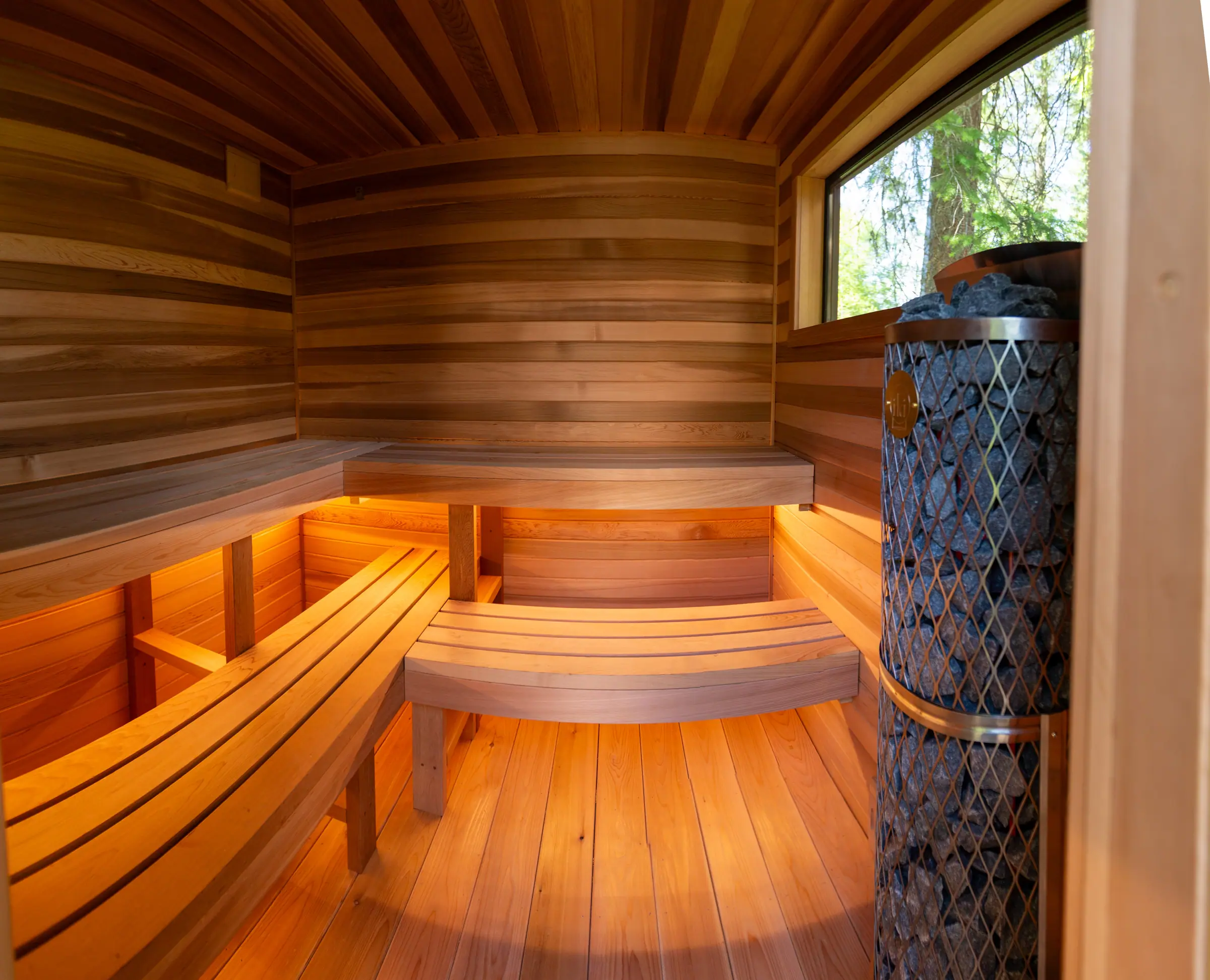 Cedar benches and an IKI stove in the corner