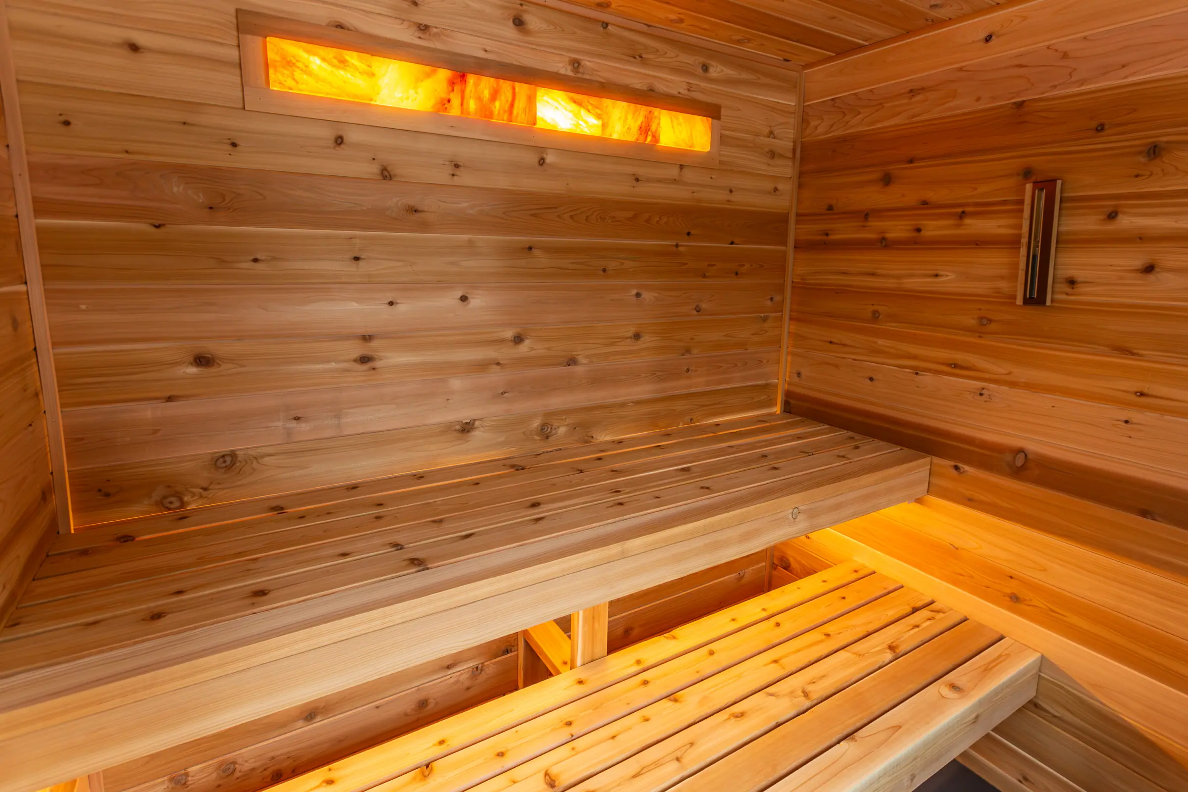 Cedar benches under a glowing backlit salt panel