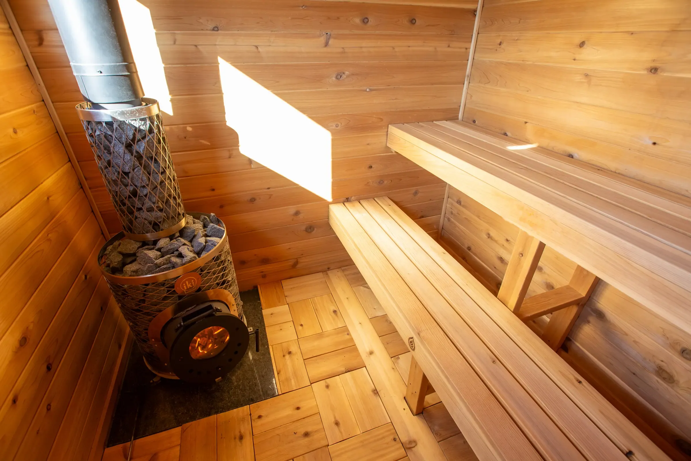Upper cedar bench lit by a high window