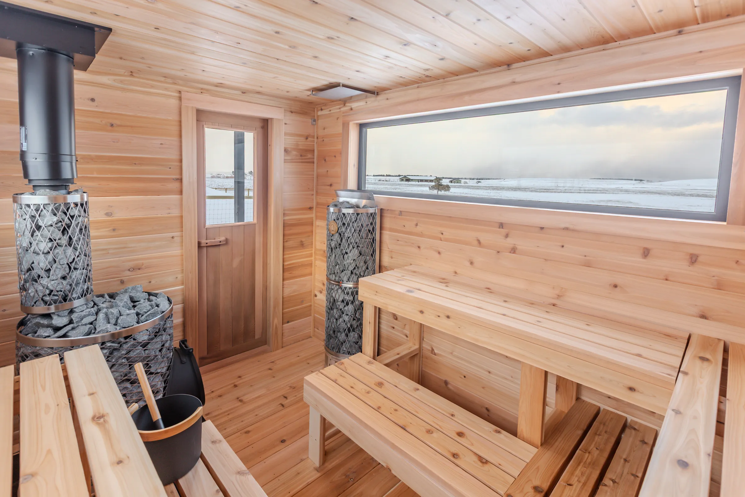 Cedar benches under a long window looking out on snow