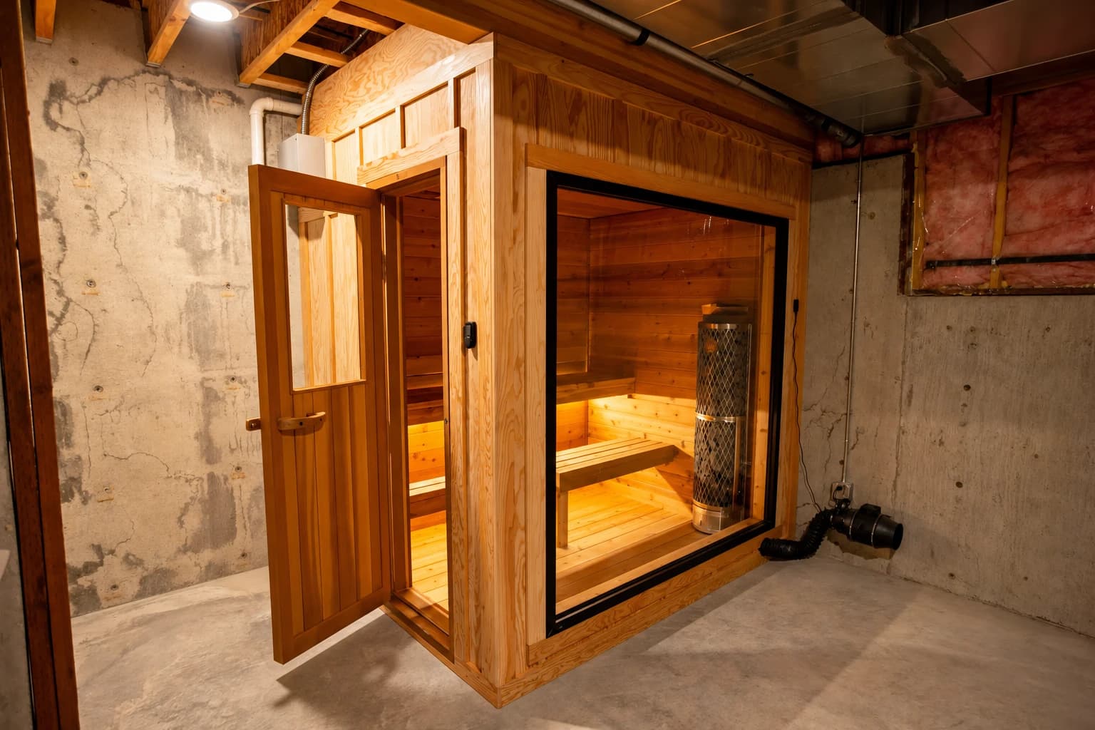 Indoor sauna with a glass front and cedar door in a basement