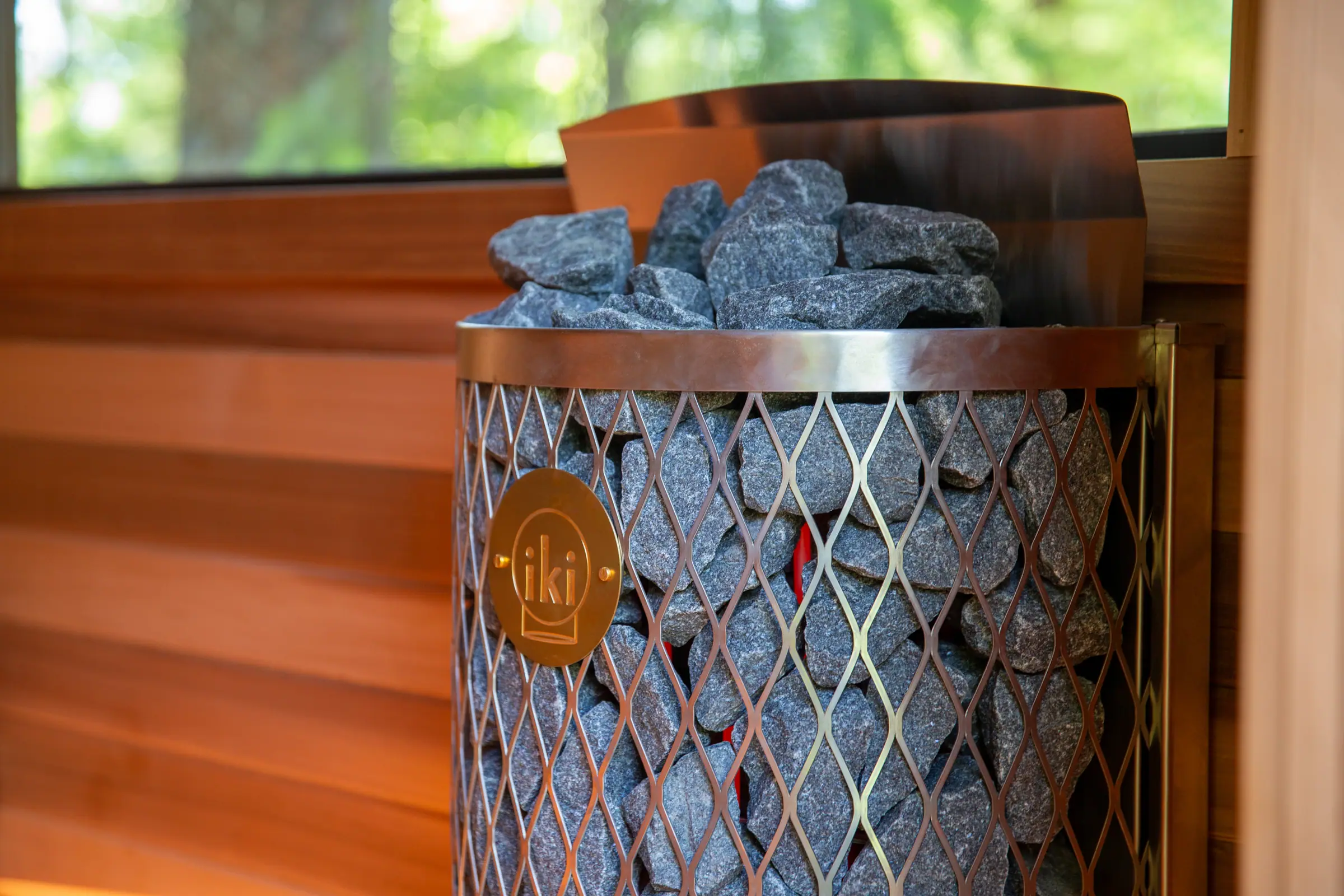 Close-up of an IKI stove's stone cage against cedar walls